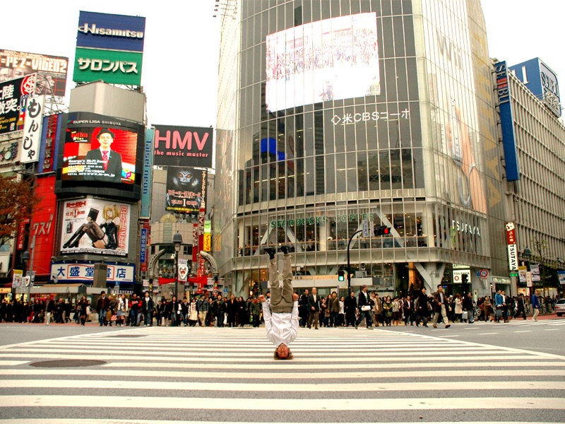 Chris Kirkland doing a headstand on a street in Shibuya, Tokyo